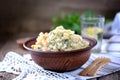 Traditional Russian salad Olivier on an old wooden background. Russian kitchen. Rustic style. Royalty Free Stock Photo