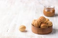 Traditional Russian  shortbread nuts with boiled condensed milk, sprinkled with powdered sugar on a wooden background Royalty Free Stock Photo