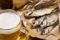 Traditional Russian snacks to beer. Dried roach on paper. Royalty Free Stock Photo