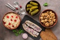 Traditional Russian snacks and vodka, sauerkraut with cranberries, herring, pickled cucumbers, pickled mushrooms and rye bread on