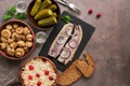 Traditional Russian snacks and vodka, sauerkraut with cranberries, herring, pickled cucumbers, pickled mushrooms and rye bread on Royalty Free Stock Photo