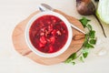 Traditional russian soup borsh with beet.served in white bowl on wooden board Royalty Free Stock Photo
