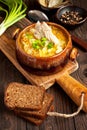 Sauerkraut soup in ceramic bowl on wooden table Royalty Free Stock Photo