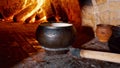 Traditional Russian stove with cooking food on wood in crock