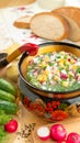 Traditional Russian summer cold okroshka soup with kefir in a bowl on a wood table. View from above. Khokhloma-style wooden dishes