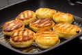 Traditional Russian sweet syrniki cottage cheese pancakes fried in the frying pan Royalty Free Stock Photo