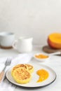 Traditional russian syrniki or cottage cheese pancakes served with mango, coffee, milk pitcher, healthy breakfast Royalty Free Stock Photo