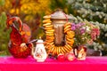 Traditional Russian table with samovar, teapot with bagels and decorations on the table outside in autumn Royalty Free Stock Photo