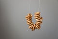 Traditional russian tasty bagels on a rope against a gray wall