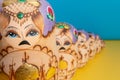 Traditional russian toys with angry face lined up on ukrainian flag Royalty Free Stock Photo