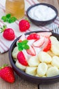 Traditional russian, ukrainian cottage cheese & x22;lazy& x22; dumplings served with yogurt, honey and strawberry