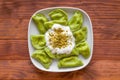 Traditional russian and ukrainian vegetarian vareniki dumplings, with sour cream and pistachios. Top view.