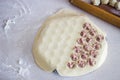 Traditional russian uncooked pelmeni on cutting board and ingredients for homemade pelmeni on white table. Process of