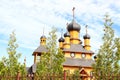 Traditional russian wooden church with domes in nature landscape. Architecture in the Orthodox religion Royalty Free Stock Photo