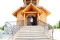 Traditional russian wooden church with domes in nature landscape. Architecture in the Orthodox religion Royalty Free Stock Photo