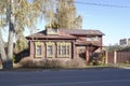 Traditional Russian wooden house with carved window frames in Pavlovsky Posad. Sunny autumn view.