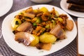 Traditional rustic dish. fried potatoes with chanterelle mushrooms and pork brisket with herbs Royalty Free Stock Photo