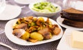 Traditional rustic dish. fried potatoes with chanterelle mushrooms and pork brisket with herbs Royalty Free Stock Photo