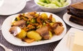 Traditional rustic dish. fried potatoes with chanterelle mushrooms and pork brisket with herbs Royalty Free Stock Photo