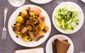 Traditional rustic dish. fried potatoes with chanterelle mushrooms and pork brisket with herbs. top view Royalty Free Stock Photo