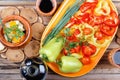 Traditional rustic home vegetable stew with raw vegetables, spices in clay pots with red wine on old vintage wooden table. Royalty Free Stock Photo