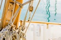 Traditional sailing boat deck, rigging tied nautical ropes on cleats on wooden mast Royalty Free Stock Photo