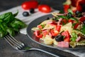 Traditional salad with pasta farfalle, ham, pepper and herbs Royalty Free Stock Photo