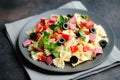 Traditional salad with pasta farfalle, ham, pepper and herbs Royalty Free Stock Photo