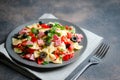 Traditional salad with pasta farfalle, ham, pepper and herbs Royalty Free Stock Photo