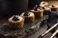 Traditional salmon fish hot roll with tare sauce in a rustic granite platter in wood background