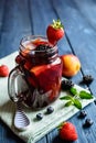 Traditional Sangria drink with red wine, tropical fruit and berries