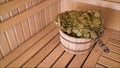 Traditional sauna stuff - birch whisk and a bucket. Wooden bucket and whisk in the sauna