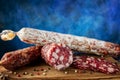 Traditional sausage and sausage with mold. Sliced sausage salami on wooden board with spices. Close-up Royalty Free Stock Photo