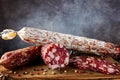 Traditional sausage and sausage with mold. Sliced sausage salami on wooden board with spices. Close-up Royalty Free Stock Photo