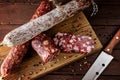 Traditional sausage and sausage with mold. Sliced sausage salami and  knife on wooden board with spices.top view Royalty Free Stock Photo