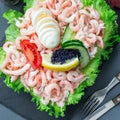 Traditional savory swedish sandwich cake Smorgastorta with a bread, shrimps, eggs, caviar, dill, mayonnaise, cucumber and lettuce