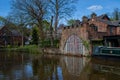 Traditional scene of a water canal with a stripy gate reflecting in the water, Worsley