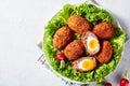 Traditional scotch eggs with lettuce and radish