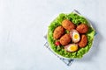 Traditional scotch eggs on a white plate