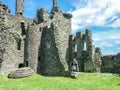 Traditional scottish bagpiper at ruins of Kilchurn castle Royalty Free Stock Photo