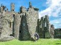 Traditional scottish bagpiper at ruins of Kilchurn castle Royalty Free Stock Photo