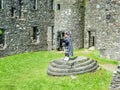 Traditional scottish bagpiper at ruins of Kilchurn castle Royalty Free Stock Photo