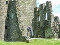 Traditional scottish bagpiper at ruins of Kilchurn castle Royalty Free Stock Photo