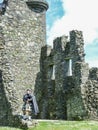 Traditional scottish bagpiper at ruins of Kilchurn castle Royalty Free Stock Photo