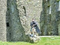 Traditional scottish bagpiper at ruins of Kilchurn castle Royalty Free Stock Photo