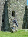 Traditional scottish bagpiper at ruins of Kilchurn castle Royalty Free Stock Photo