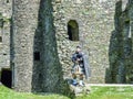 Traditional scottish bagpiper at ruins of Kilchurn castle Royalty Free Stock Photo