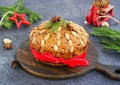 A traditional Scottish Christmas fruit Dundee cake with a mix of dried fruits, decorated with peeled almonds on a wooden board on
