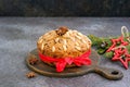 A traditional Scottish Christmas fruit Dundee cake with a mix of dried fruits, decorated with peeled almonds on a wooden board on