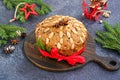 A traditional Scottish Christmas fruit Dundee cake with a mix of dried fruits, decorated with peeled almonds on a wooden board on